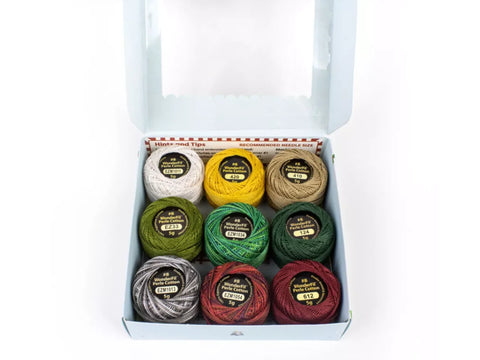 Nine spools of WonderFil Eleganza Perle Cotton thread in various colors.