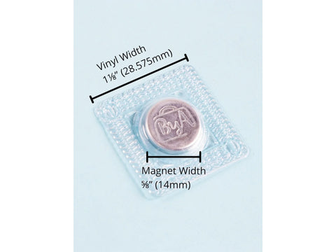 A clear vinyl sew-in magnet with a silver magnet, measuring 1 1/8" vinyl and 5/8" magnet.