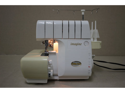 A white and beige Baby Lock Imagine 2 serger with visible controls and threading mechanisms.