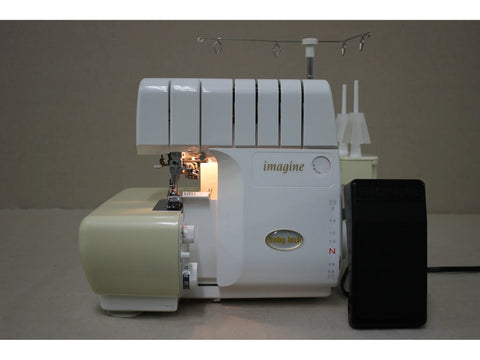 A white and beige Baby Lock Imagine 2 serger with a black foot pedal.