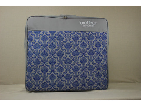 Brother sewing machine carrying case with blue damask pattern.