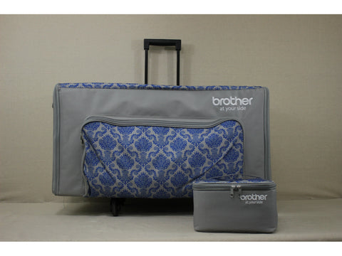 A gray rolling sewing machine case with a blue patterned pocket and a smaller matching bag.