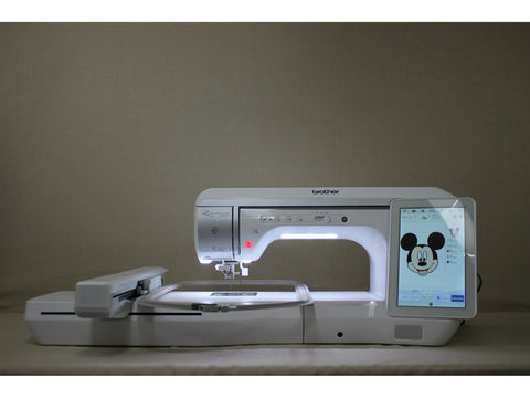 A white Brother Luminaire Innov-is XP1 sewing and embroidery machine with a Mickey Mouse design on the screen.