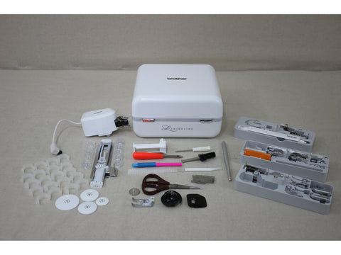 A Brother Luminaire Innov-is XP1 sewing and embroidery machine with various accessories.