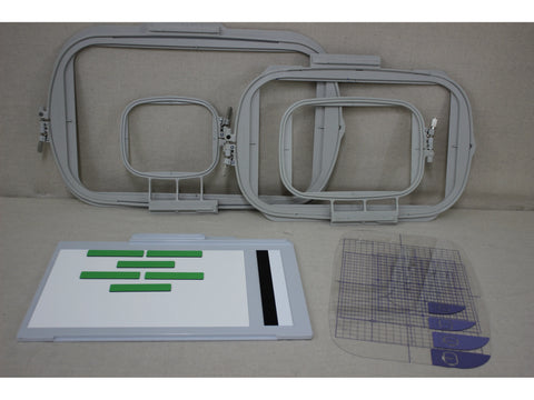 Three gray embroidery hoops, a white and gray magnetic frame, and a clear grid with purple templates.