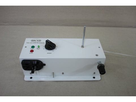 A white Baby Lock bobbin winder with a speed dial, start/stop buttons, and a thread guide.