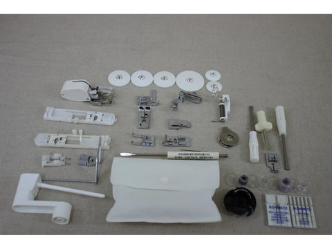 A collection of white and silver sewing machine accessories, including presser feet, bobbins, and tools.