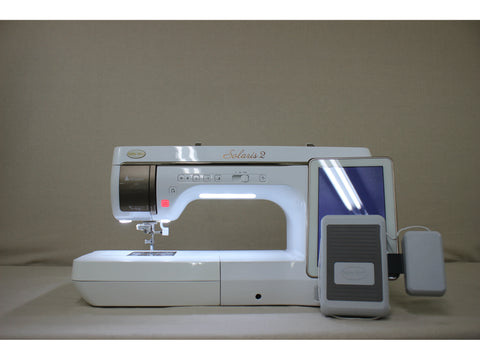 A white Baby Lock Solaris 2 sewing and embroidery machine with a touchscreen display.