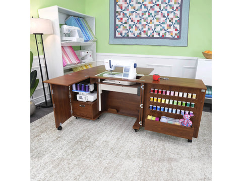 A brown sewing cabinet with an electric lift, storage, and a sewing machine.