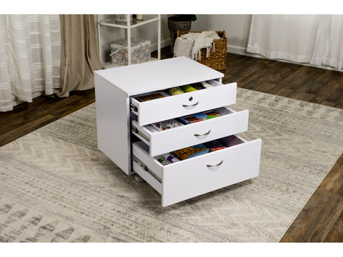 White three-drawer sewing companion chest with open drawers on a patterned rug.