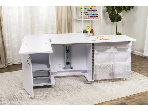 White sewing and embroidery studio with storage and adjustable platform.