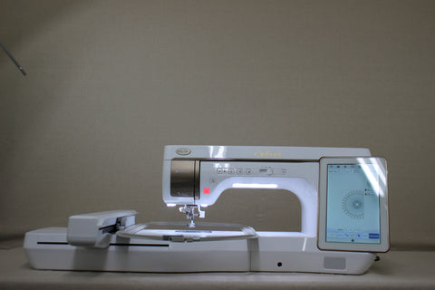 A white Baby Lock Solaris sewing and embroidery machine with a digital display.