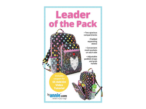 A black backpack with colorful polka dots and a matching lunch bag with a wolf design.