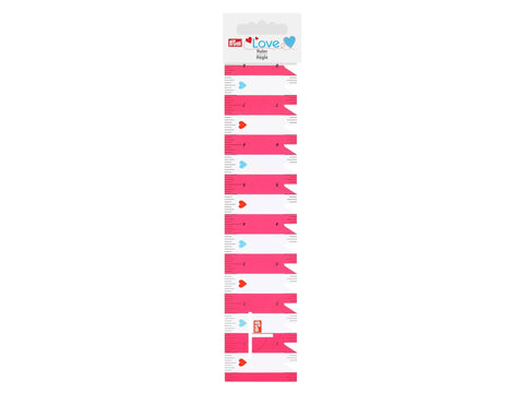 A pink and white Prym Love ruler with heart accents.