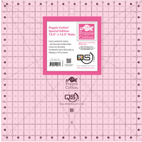 A pink 12.5" x 12.5" quilting ruler with a Poppie Cotton label.