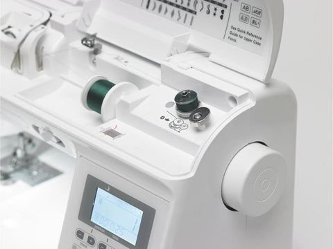 A white Baby Lock Presto II sewing and quilting machine with green thread.
