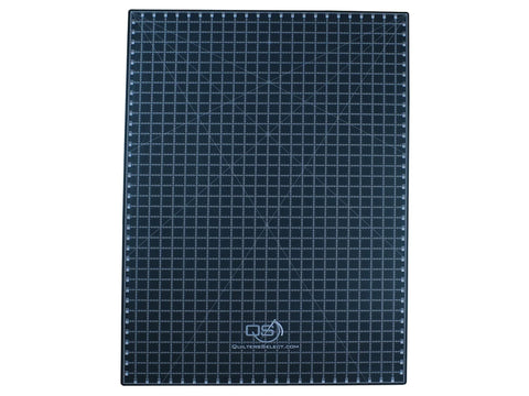 A black Quilters Select dual-sided cutting mat with a grid and measurements.