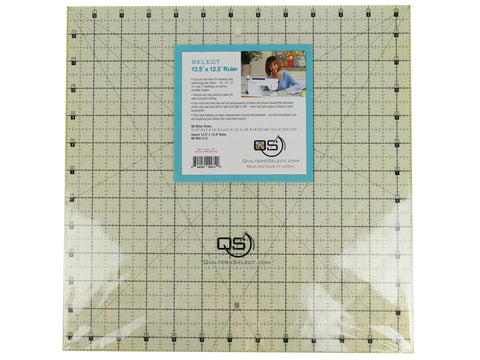 A clear, square 12.5" x 12.5" quilting ruler with black grid lines and a blue label.