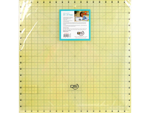 A clear 18 by 18 inch quilting ruler with a blue label.