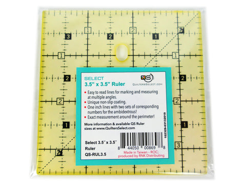A clear yellow 3.5 by 3.5 inch quilting ruler with black markings and a white label.