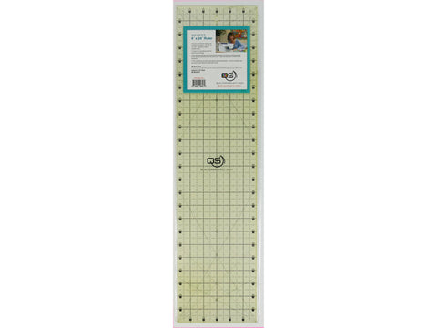 A clear, rectangular Quilters Select 6.5" x 24" ruler with black grid lines.