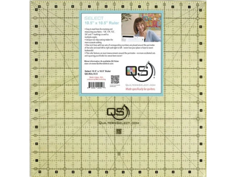 A square, clear quilting ruler with black grid lines and a product label.