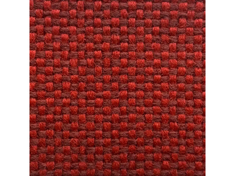 Close-up of a ruby red woven fabric with a basketweave pattern.