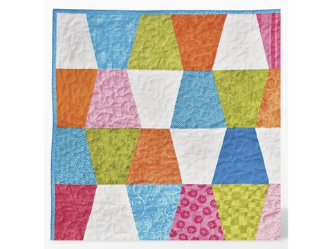 A colorful quilted blanket features rows of trapezoidal fabric blocks in various patterns.