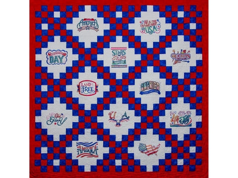 A patriotic quilt features red, white, and blue checkerboard patterns and embroidered American-themed designs.