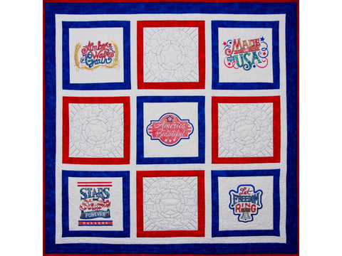 A patriotic quilt features nine squares with embroidered phrases and star patterns.
