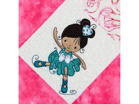 An embroidered ballerina with dark hair and a teal dress and shoes on a white fabric square.