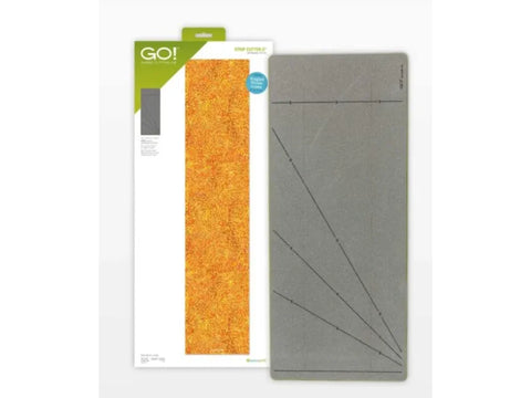 An AccuQuilt GO! Strip Cutter - 5" (4-1/2" Finished) with an orange fabric sample.