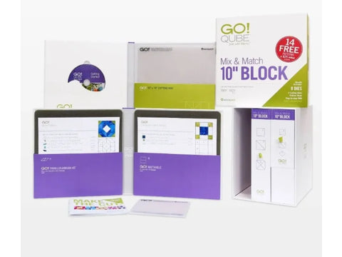 A collection of AccuQuilt Qube Mix & Match 10" Block quilting supplies.