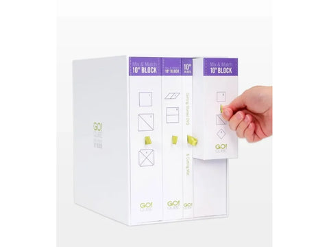 A white box set with purple labels for a 10" block, with a hand pulling out a component.