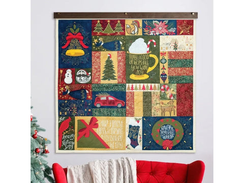 A Christmas-themed quilt featuring various holiday designs and phrases.