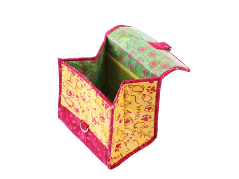 A yellow and pink patterned lunch bag with a green floral interior and mesh pocket.