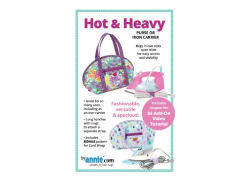 A floral patterned bag with purple handles and a pink iron inside.