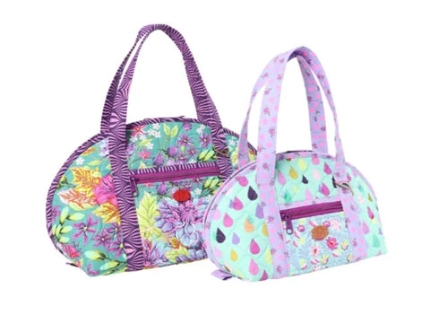 Two quilted bags, one with a floral pattern and the other with a raindrop design.