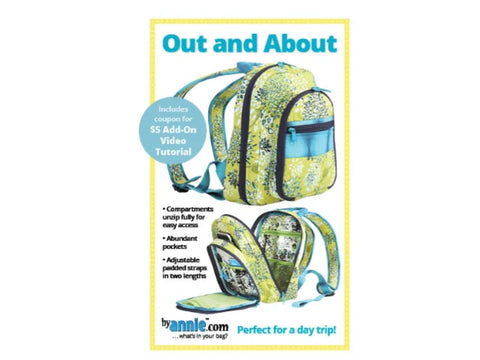 A green and blue floral backpack with multiple compartments, one unzipped to show the interior.