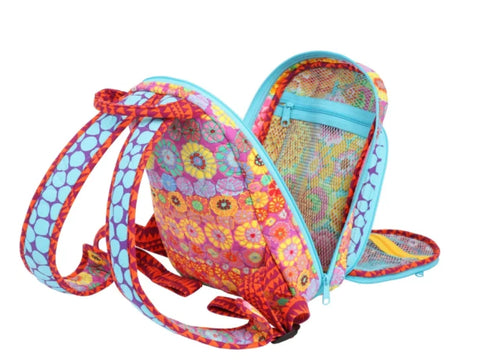 A vibrant floral backpack with an open main compartment revealing a mesh pocket.