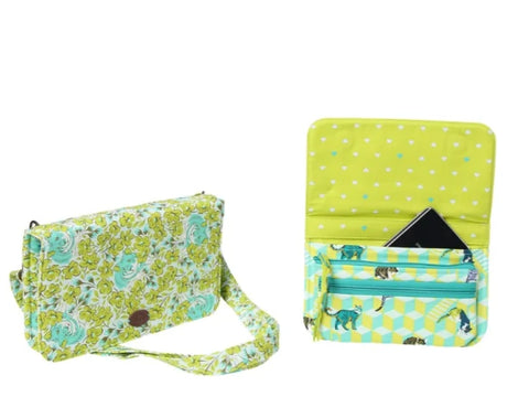 A green and white floral patterned wallet with a shoulder strap, shown closed and open with a phone inside.