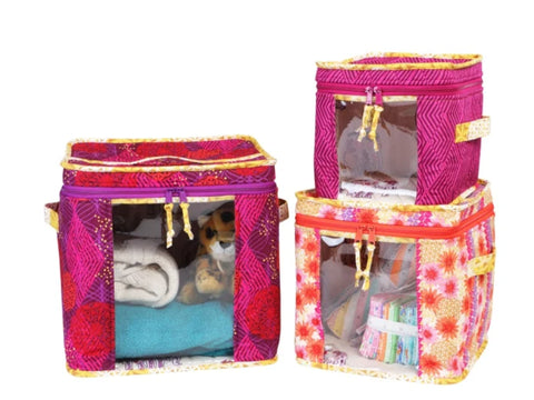Three colorful fabric storage bins with clear vinyl windows display various items.