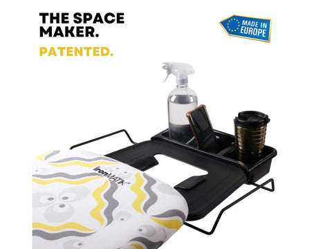 IronMatik Space Maker ironing board with a black accessory tray and a patterned cover.