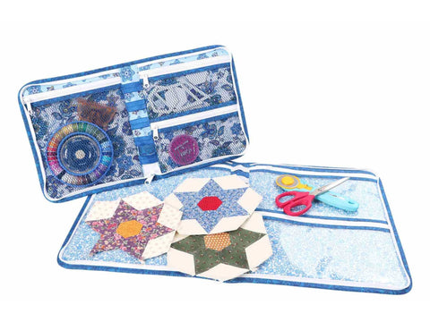 A blue patterned fabric organizer with zippers, mesh pockets, and quilt blocks.