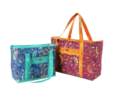 Two quilted tote bags, one blue and one purple, with butterfly patterns.
