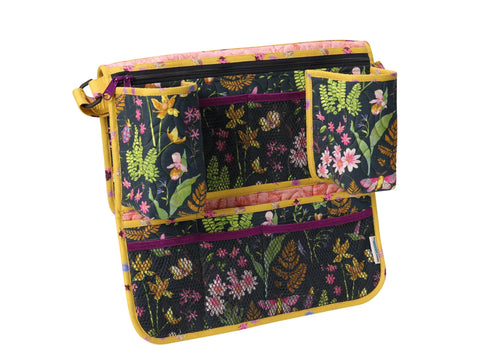 Backseat organizer with a dark floral pattern, yellow trim, and mesh pockets.