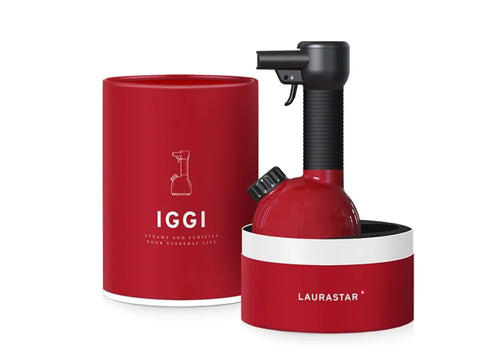 Red handheld garment steamer and purifier with a matching cylindrical case.