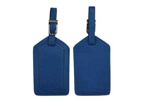 Two cobalt blue leather luggage tags are displayed, one showing the front and one the back.