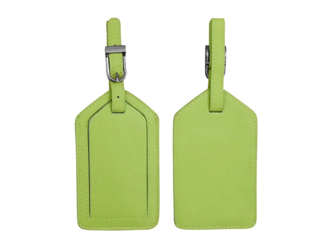 Two pear-colored leather luggage tags are displayed against a white background.