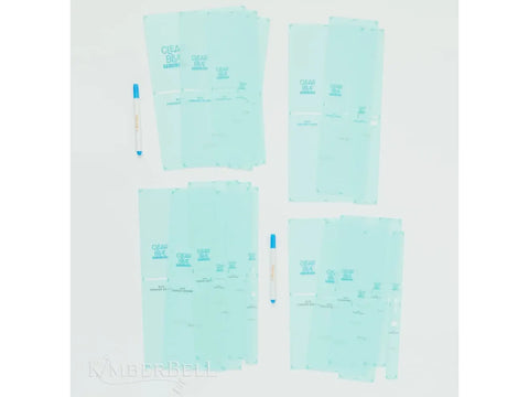 Four stacks of light blue quilting templates and two blue-capped pens are arranged on a white surface.